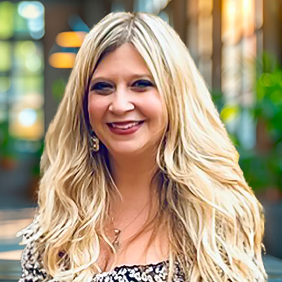 "Professional headshot of Justine Basile, M.Ed., NCC, a school counselor specializing in anxiety disorders, depression, mood disorders, and trauma recovery.